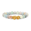 Morganite bracelet with soft pink, peach, cream, and pale green polished beads, centered by a gold Pixiu charm on a clean white background for a clear product view in full details.