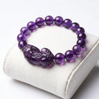 Natural amethyst bracelet on jewelry cushion with polished gemstone beads and crystal elegance appeal
