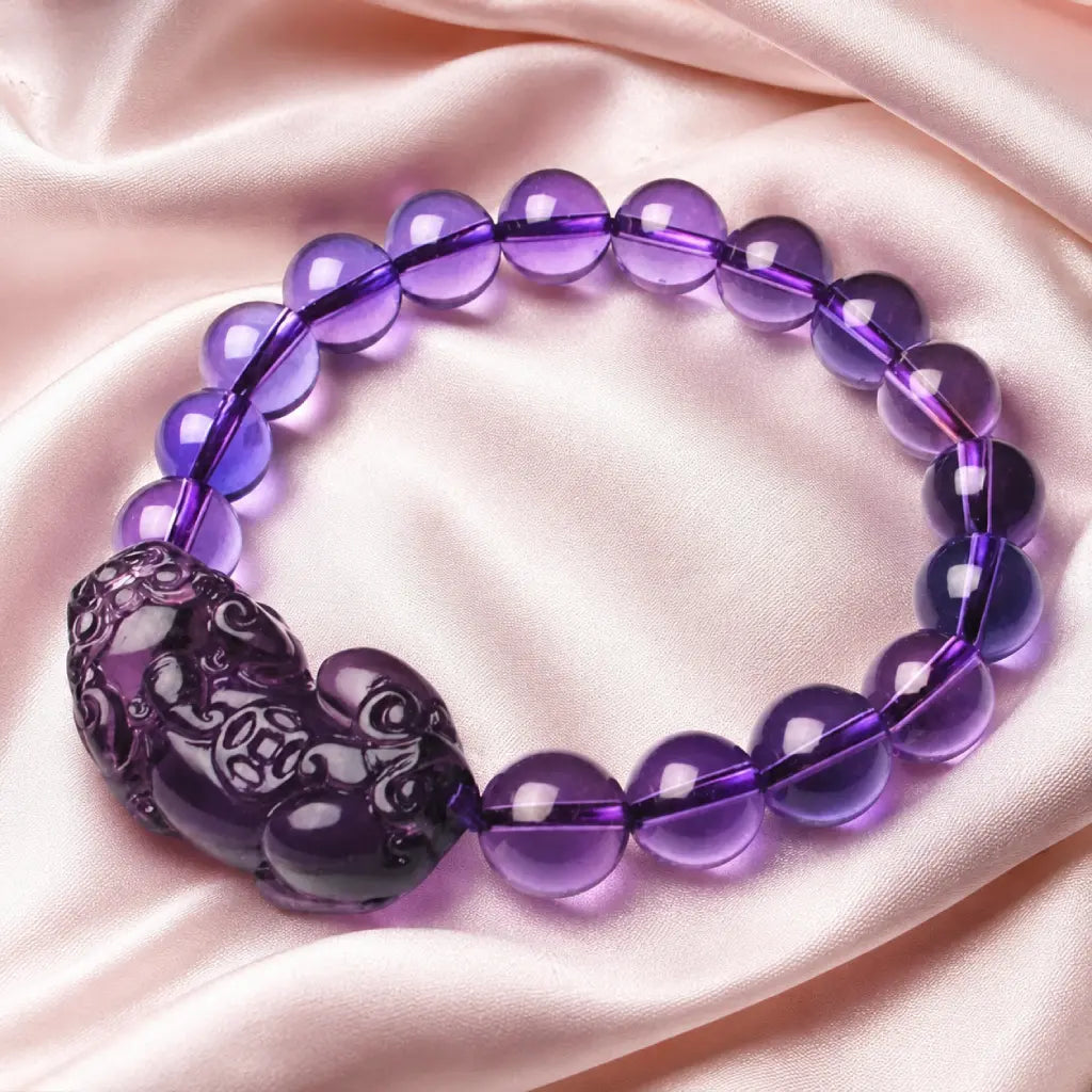 Natural amethyst bracelet on soft silk with polished gemstone beads and healing crystal energy styling