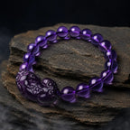 Natural amethyst bracelet on layered slate stone featuring purple gemstone beads and crystal jewelry appeal
