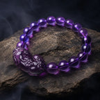 Natural amethyst bracelet displayed on natural rock featuring gemstone beads and healing crystal energy style