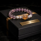 Natural ametrine citrine healing crystal bracelet with pearl accents on premium luxury jewelry display.