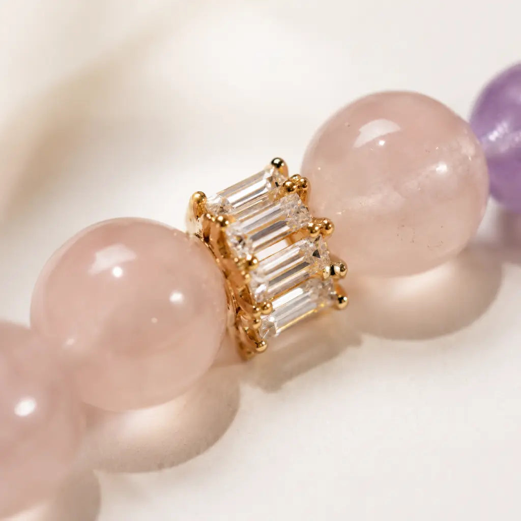 Natural Rose Quartz Amethyst Clear Quartz Crystal bracelet close-up with gold spacer and luxury gemstone details.
