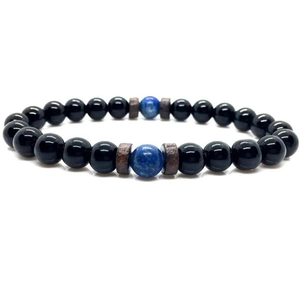 Obsidian lapis lazuli bracelet with polished black obsidian beads, blue lapis lazuli center stone, and wood spacers on a white background.