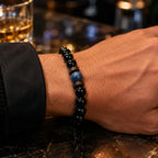 Obsidian lapis lazuli bracelet close-up with polished black gemstone beads and natural blue stone centerpiece for premium handcrafted jewelry.