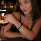 Obsidian lapis lazuli bracelet styled with an espresso martini, showcasing polished gemstone beads for modern evening fashion.
