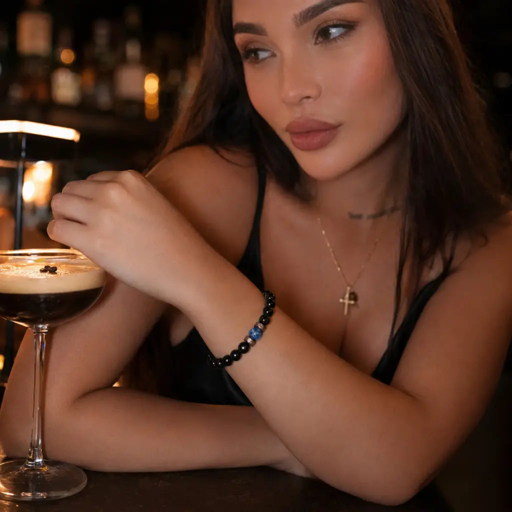 Obsidian lapis lazuli bracelet styled with an espresso martini, showcasing polished gemstone beads for modern evening fashion.