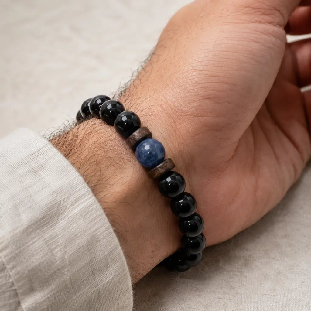 Obsidian lapis lazuli bracelet paired with casual neutral clothing, featuring polished black gemstone beads for timeless elegance.
