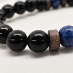 Obsidian lapis lazuli bracelet close-up highlighting glossy black gemstone beads and handcrafted wood spacers for premium quality.