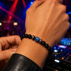 Obsidian lapis lazuli bracelet styled at a nightlife venue, showcasing polished gemstone beads for sophisticated evening fashion.