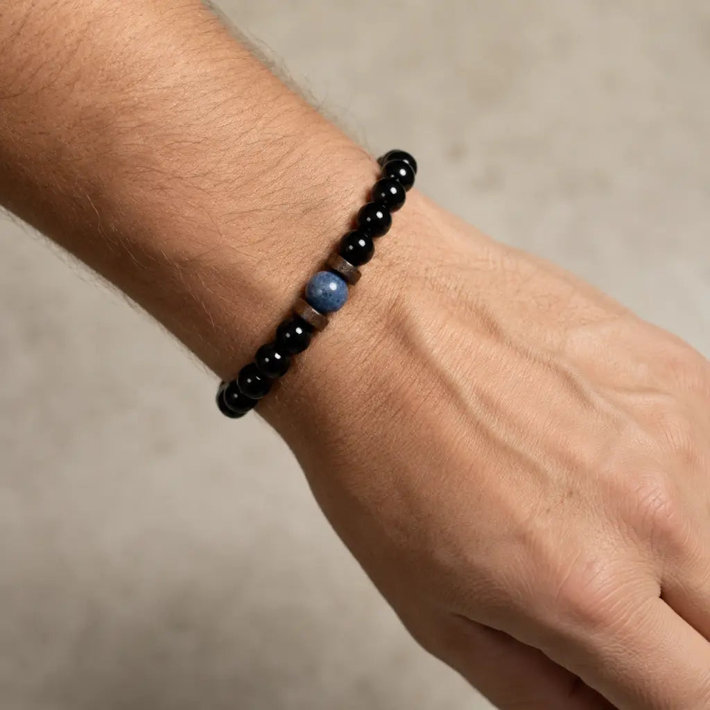 Obsidian lapis lazuli bracelet worn casually on the wrist with polished gemstone beads for versatile everyday luxury.