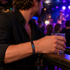 Obsidian lapis lazuli bracelet worn at a live music venue with polished gemstone beads for bold contemporary style.