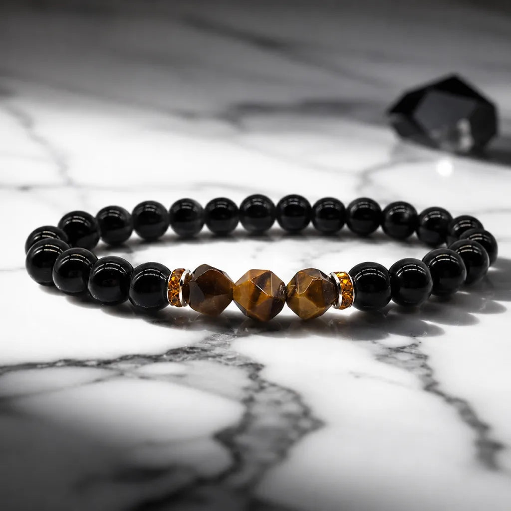 Obsidian tiger eye black bead bracelet displayed on marble, grounding crystal jewelry for mental clarity