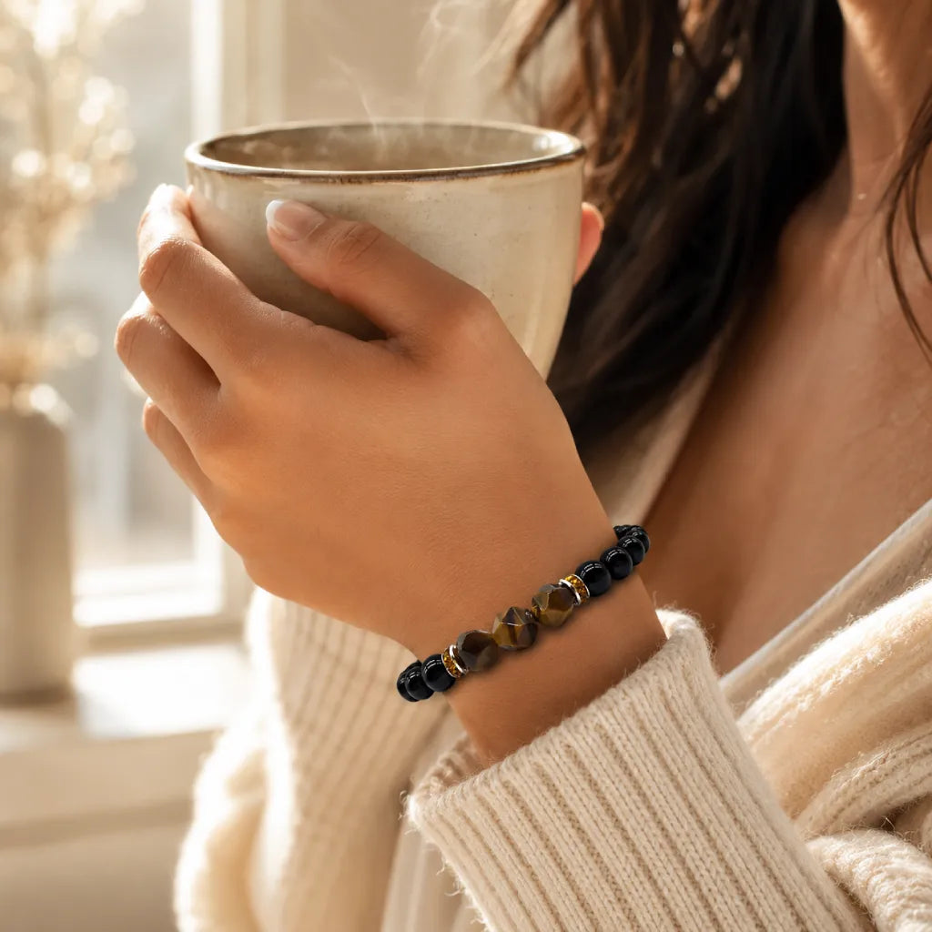 Obsidian tiger eye healing bracelet paired with warm tea, elegant gemstone jewelry for mindful relaxation
