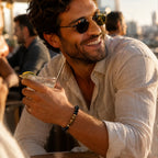 Obsidian tiger eye bracelet styled on fashionable man at sunset rooftop, luxury crystal jewelry for confidence