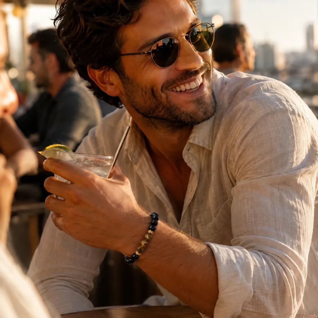 Obsidian tiger eye bracelet styled on fashionable man at sunset rooftop, luxury crystal jewelry for confidence