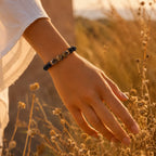 Obsidian tiger eye bracelet styled outdoors at sunset, grounding crystal accessory for confidence and strength