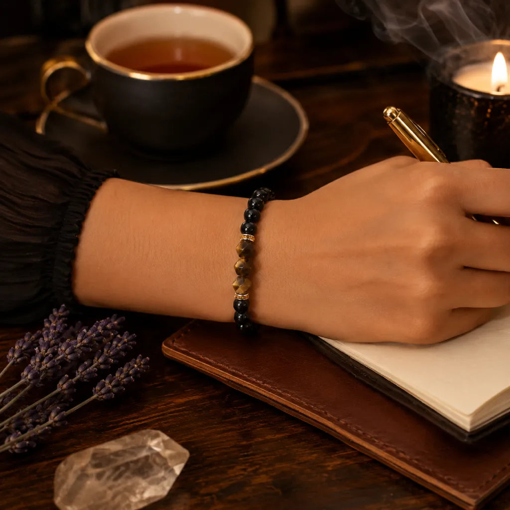 Obsidian tiger eye bracelet worn while journaling, grounding crystal jewelry promoting calm focus and balance