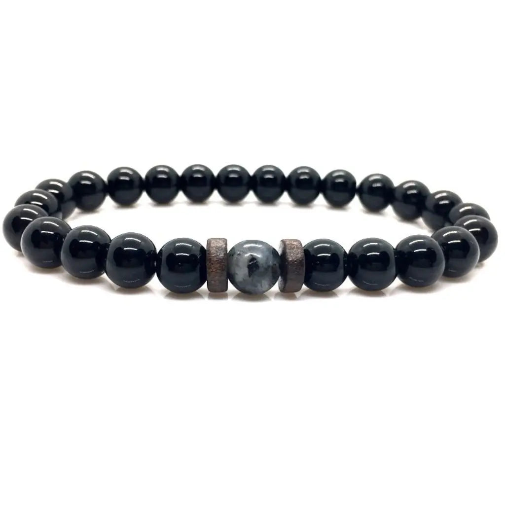 Black beaded bracelet with a wooden accent on a white background