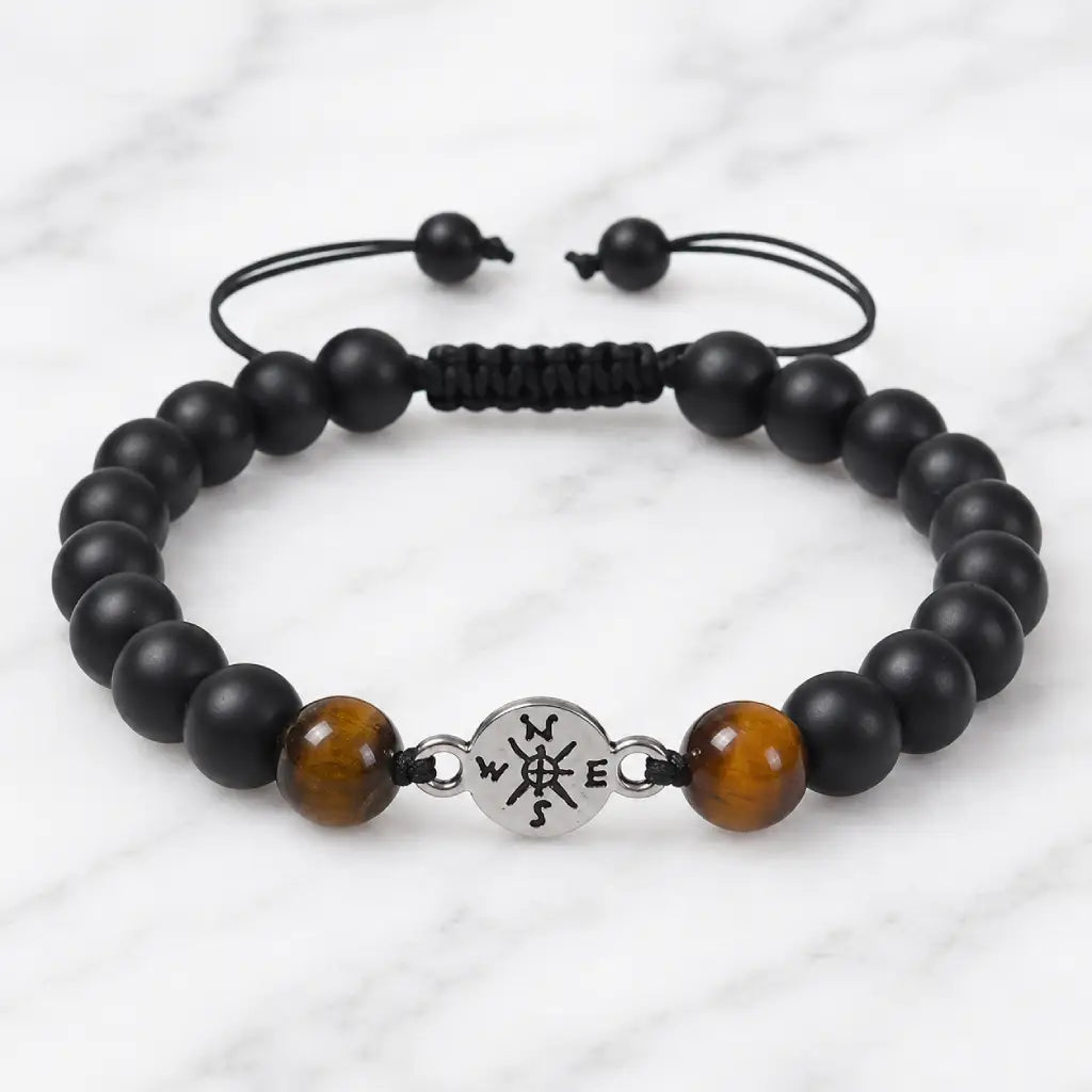 Onyx and Tiger eye bracelet featuring matte black beads and natural gemstones on modern marble background.