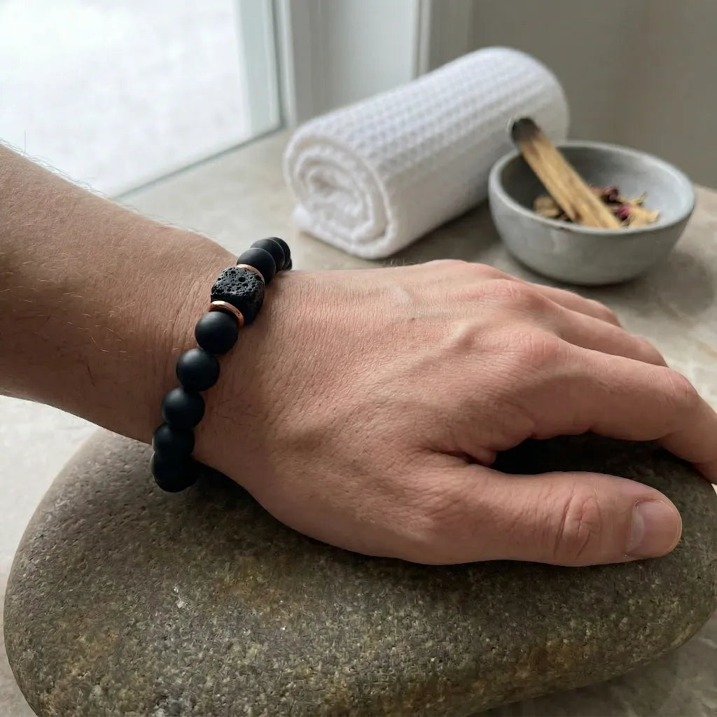 Onyx lava bracelet worn on wrist with matte black beads, grounding diffuser stone style calming energy for protection