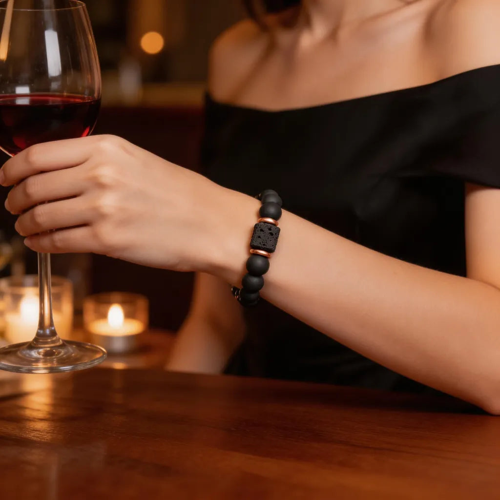 Person holding a glass of red wine with a blurred background