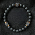 Onyx lava bracelet on black fabric with matte beads and lava stone details, protective crystal energy jewelry