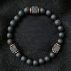 Onyx lava bracelet on black fabric with matte beads and lava stone details, protective crystal energy jewelry