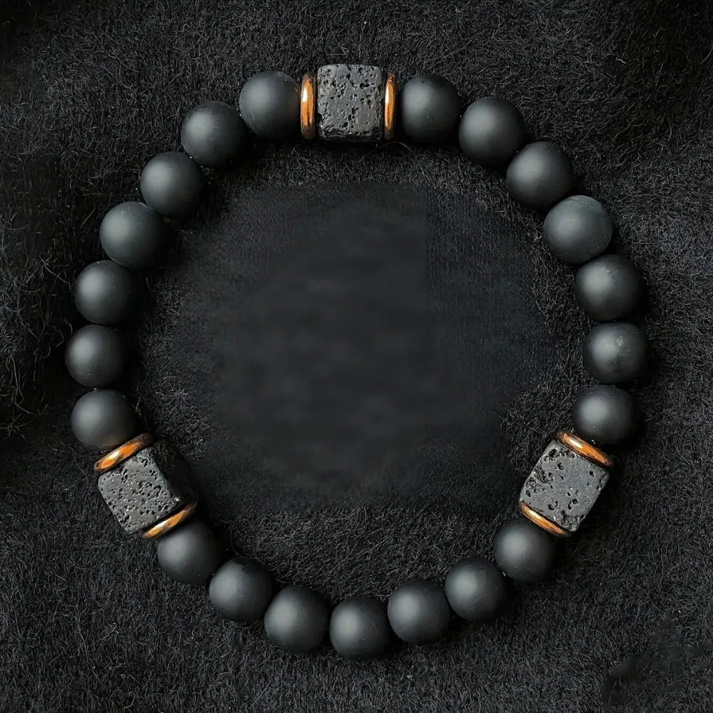 Onyx lava bracelet on black fabric with matte beads and lava stone details, protective crystal energy jewelry