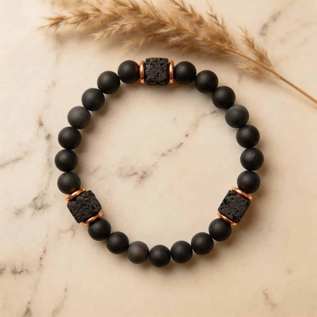 Black beaded bracelet with lava rock accents on a marble surface