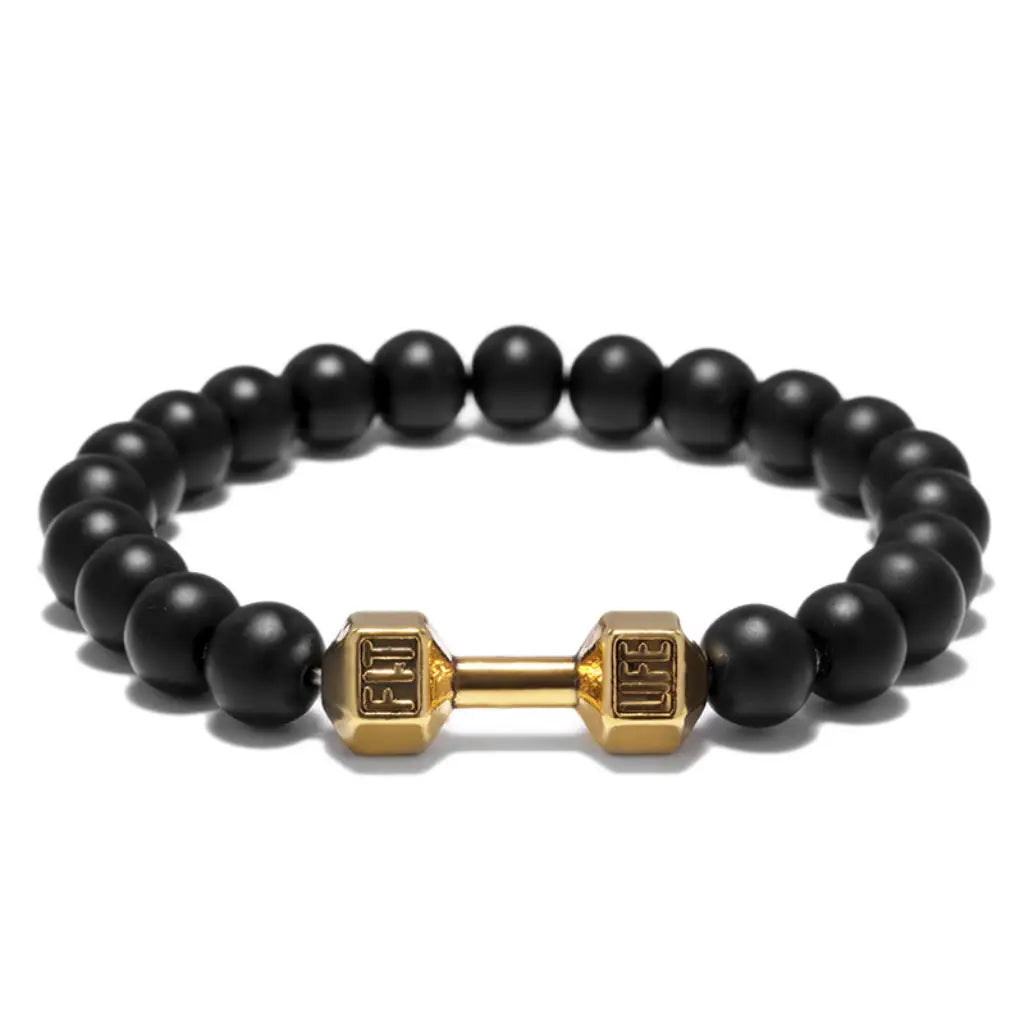 Onyx stone bracelet featuring gold dumbbell charm and black beads, blending luxury design with fitness inspiration for bold modern look