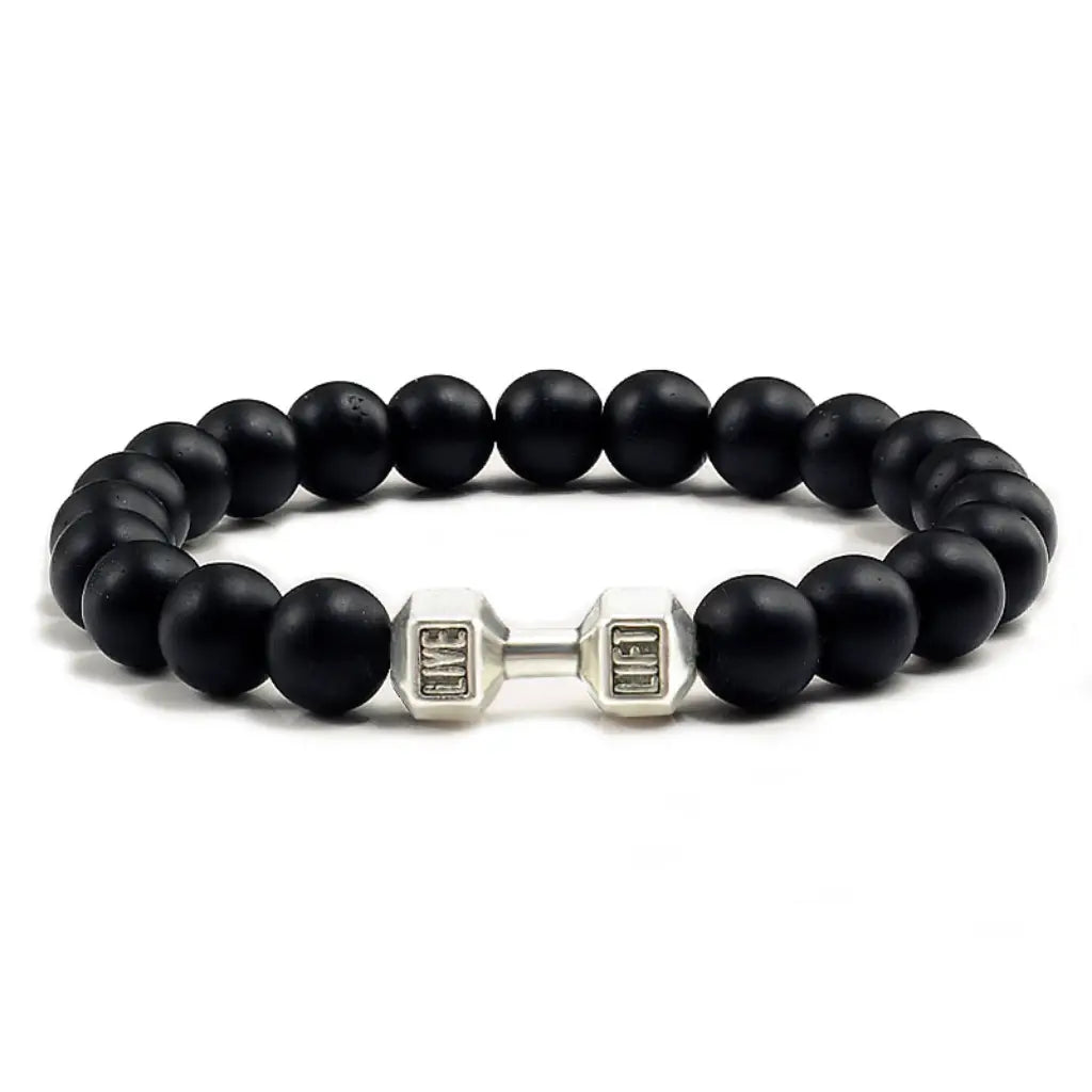 Onyx stone bracelet with matte black beads and silver dumbbell charm in clean display, perfect for modern men’s jewelry styling