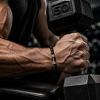Onyx stone bracelet product display with black beads and silver dumbbell charm, ideal for stylish fitness enthusiasts and gifting