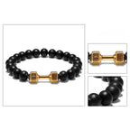Onyx stone bracelet with gold dumbbell accent, combining luxury style and fitness inspiration for bold and confident everyday wear