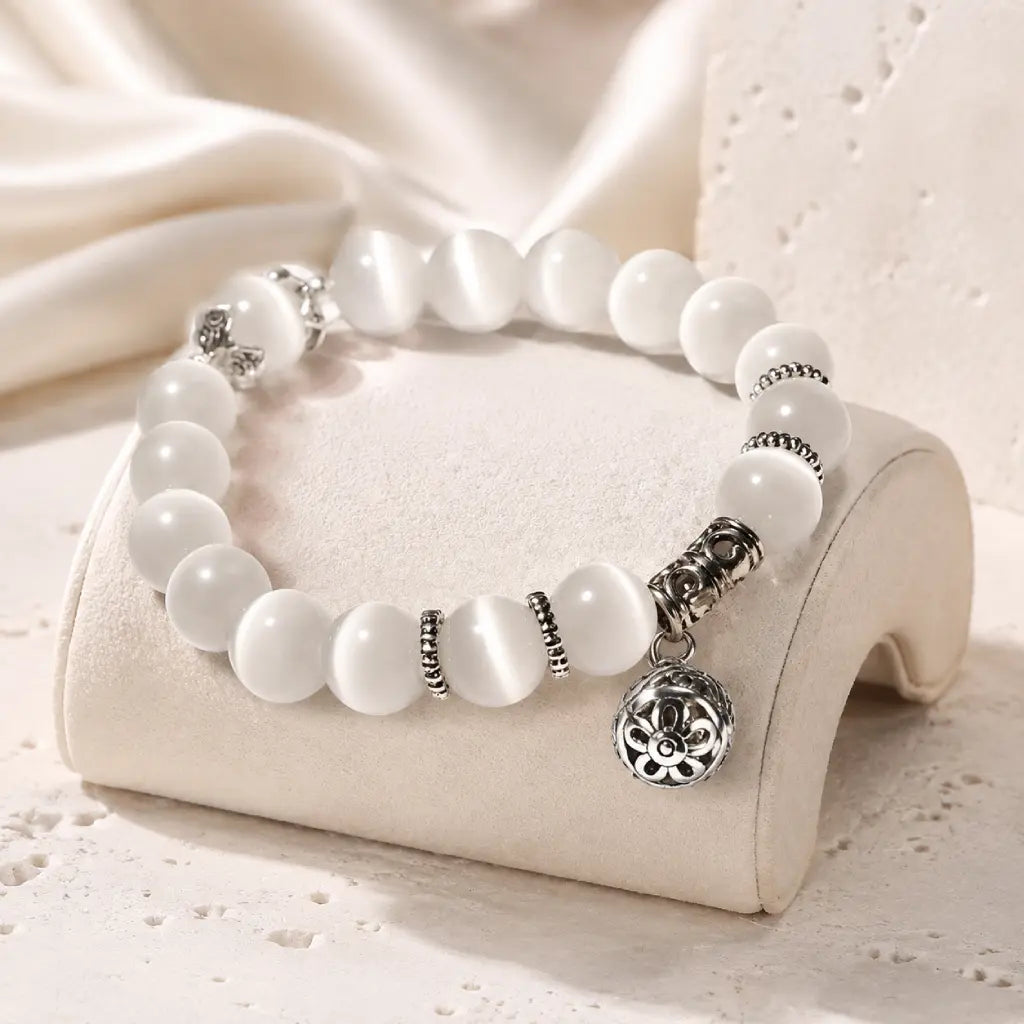 Moonlit Inspiration Opal Bracelet with luminous white natural Opal beads, silver-tone spacer details, and an ornate floral charm shown in a polished product view for everyday wear.