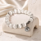 Moonlit Inspiration Opal Bracelet with luminous white natural Opal beads, silver-tone spacer details, and an ornate floral charm shown in a polished product view for everyday wear.