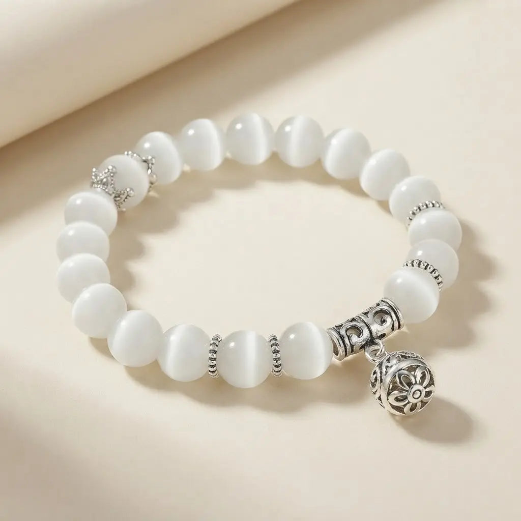 Moonlit Inspiration Opal Bracelet with polished white natural Opal beads, silver-tone details, and an ornate floral charm displayed as meaningful everyday gemstone jewelry in view.