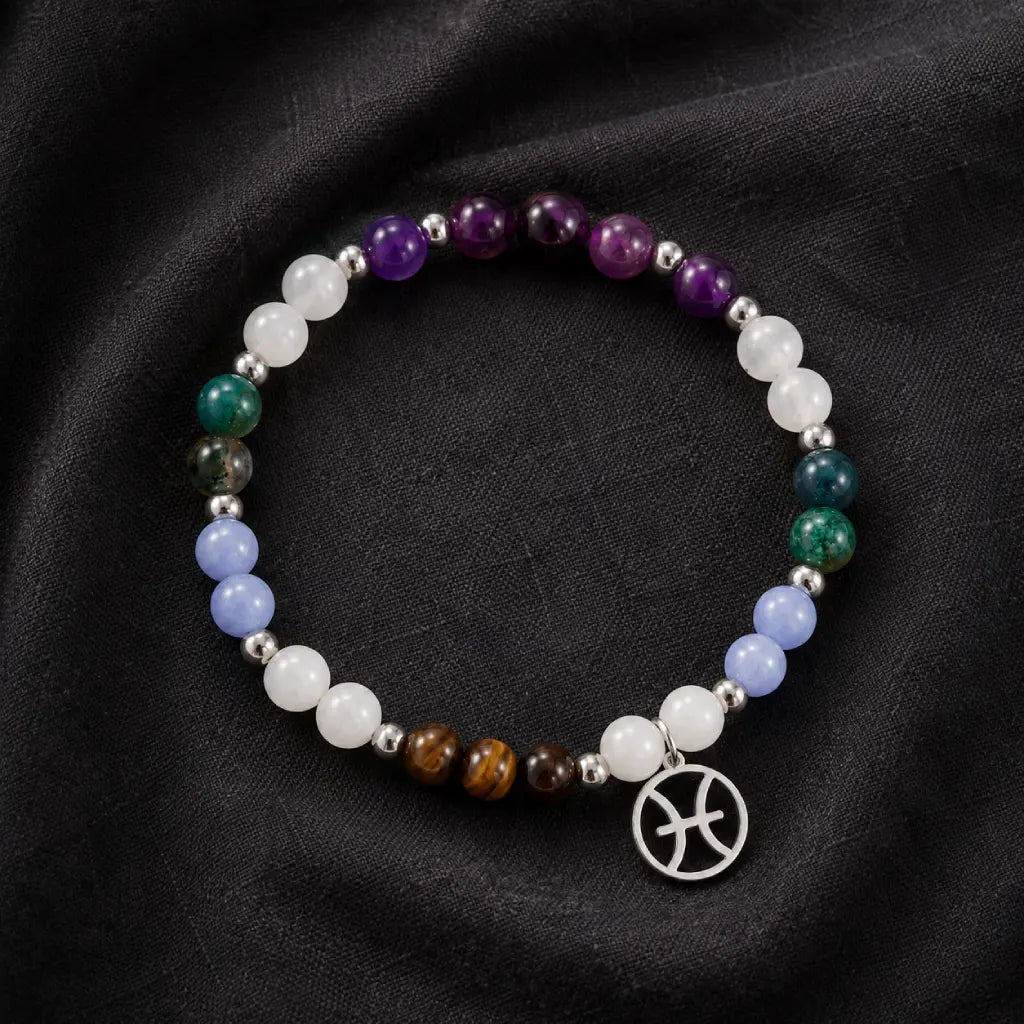 Pieces zodiac bracelet arranged on luxury fabric featuring healing crystal gemstones and zodiac jewelry craftsmanship