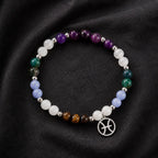 Pieces zodiac bracelet arranged on luxury fabric featuring healing crystal gemstones and zodiac jewelry craftsmanship