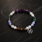 Pieces zodiac gemstone bracelet displayed on marble surface featuring Pisces charm and polished crystal bead details