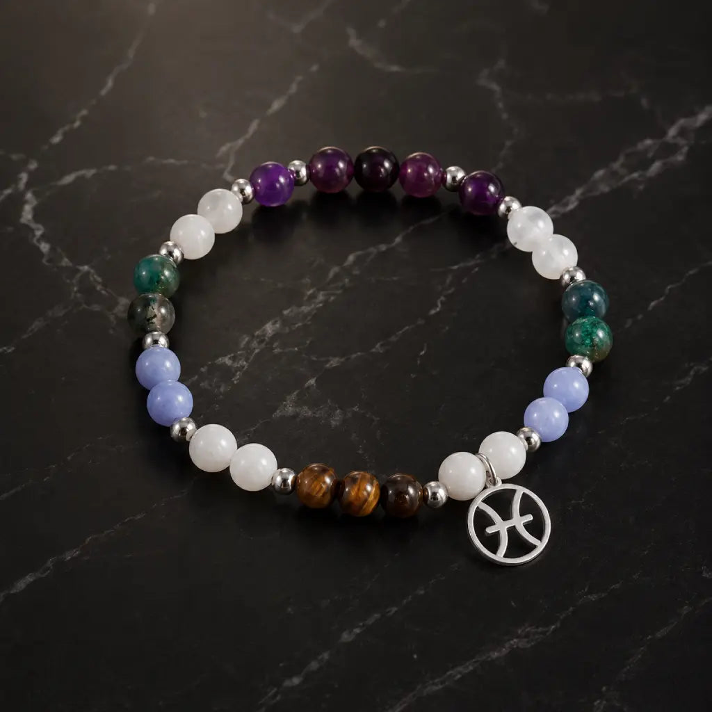 Pieces zodiac gemstone bracelet displayed on marble surface featuring Pisces charm and polished crystal bead details