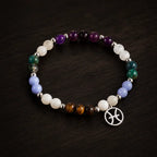 Pieces zodiac bracelet displayed on rich wood surface featuring astrology jewelry and colorful gemstone beads
