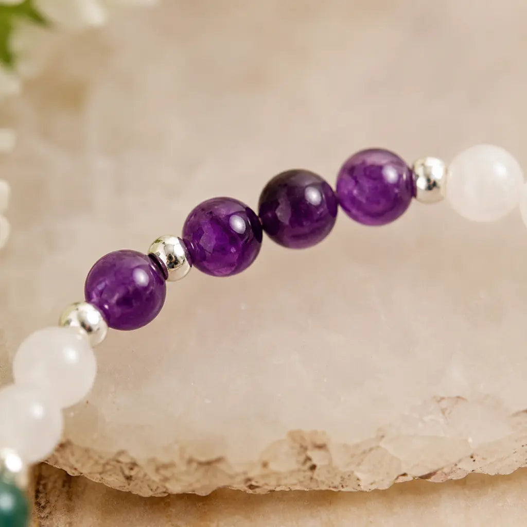 Pieces zodiac gemstone bracelet closeup featuring amethyst beads and astrology jewelry design for meaningful gifts