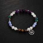 Pieces zodiac gemstone bracelet photographed on dark stone surface with Pisces charm and premium crystal beads