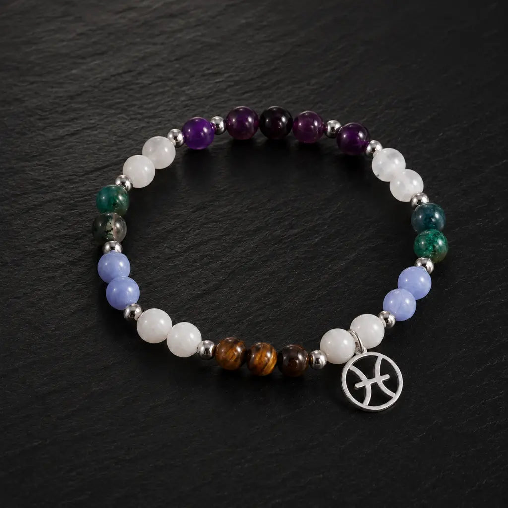 Pieces zodiac gemstone bracelet photographed on dark stone surface with Pisces charm and premium crystal beads