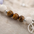 Pieces zodiac gemstone bracelet macro view highlighting tiger eye beads and luxury astrology jewelry materials