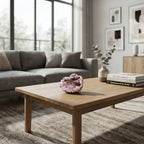 Pink amethyst geode displayed on a modern coffee table, showcasing sparkling natural crystals as elegant home décor accents.