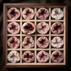 Pink amethyst geode collection arranged in a display tray with sparkling natural crystal formations for collectors and luxury décor.