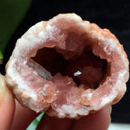 Pink amethyst geode featuring sparkling pink quartz crystals inside a natural geode, perfect for luxury home décor and gifting.