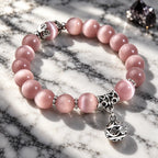 Pink Catseye bracelet featuring glossy pink cat eye beads and ornate silver accents, designed for a sophisticated look.